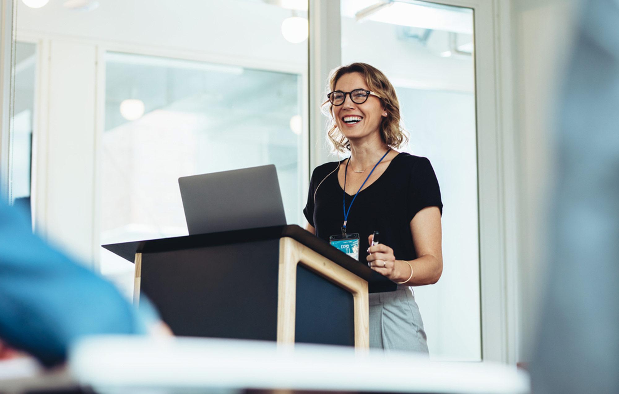 female worker at a podium presenting a training