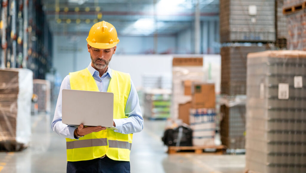 warehouse manager working on his laptop