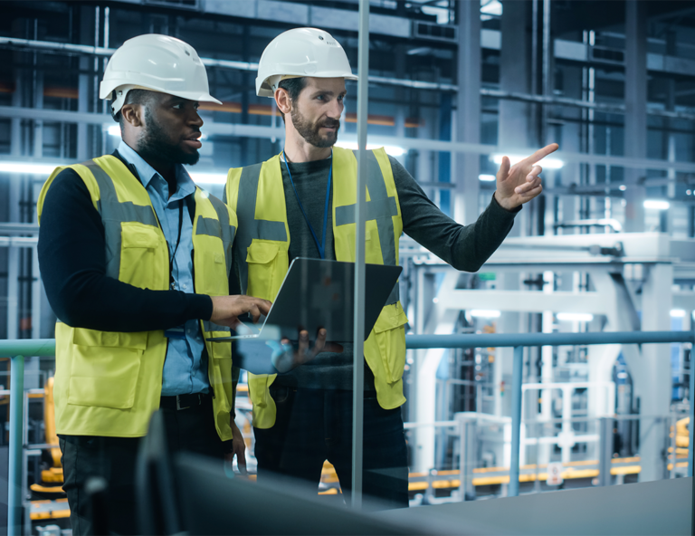 two-factory-workers-inspecting-using-a-laptop