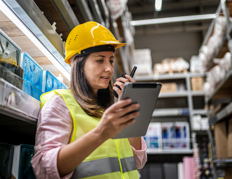 woman-in-hard-hat-using-tablet-and-walkie-talkie