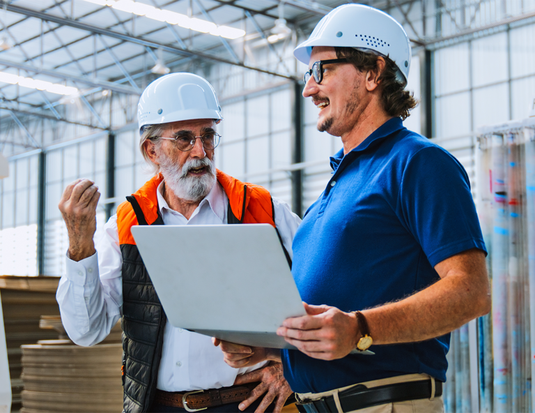 two-men-in-hard-hats-talking