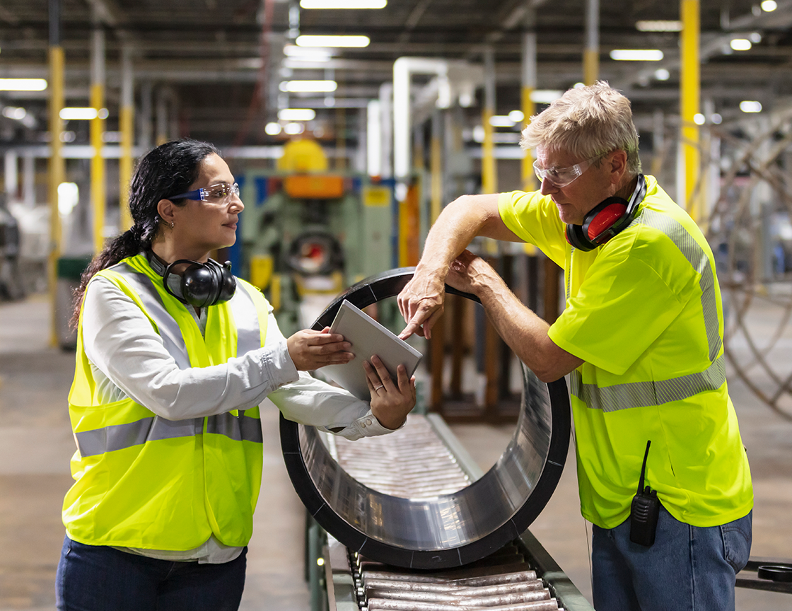 manufacturing-workers-looking-at-tablet