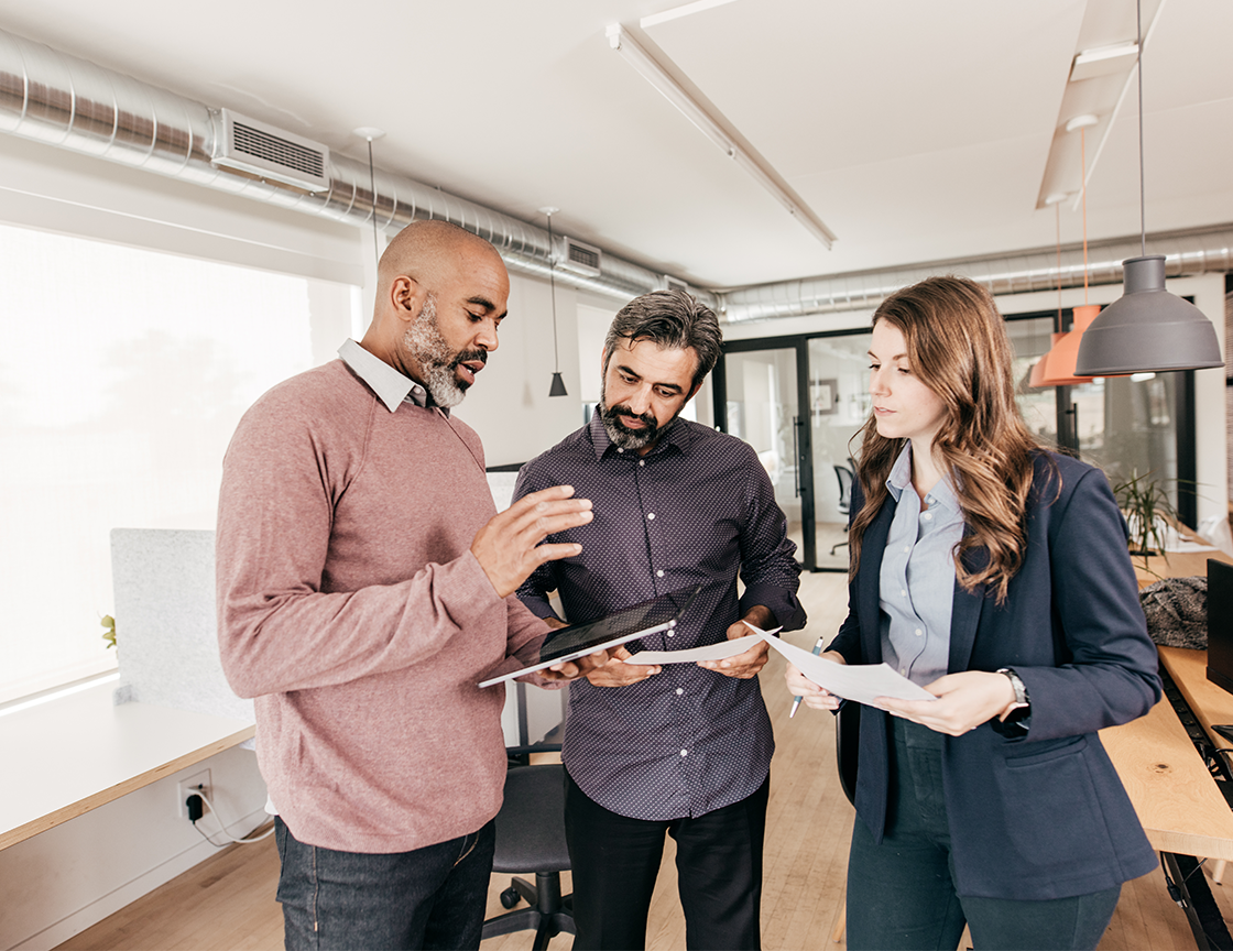 two-men-and-a-woman-looking-at-documents