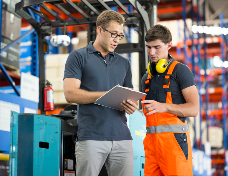 two-men-one-in-ppe-looking-at-clipboard