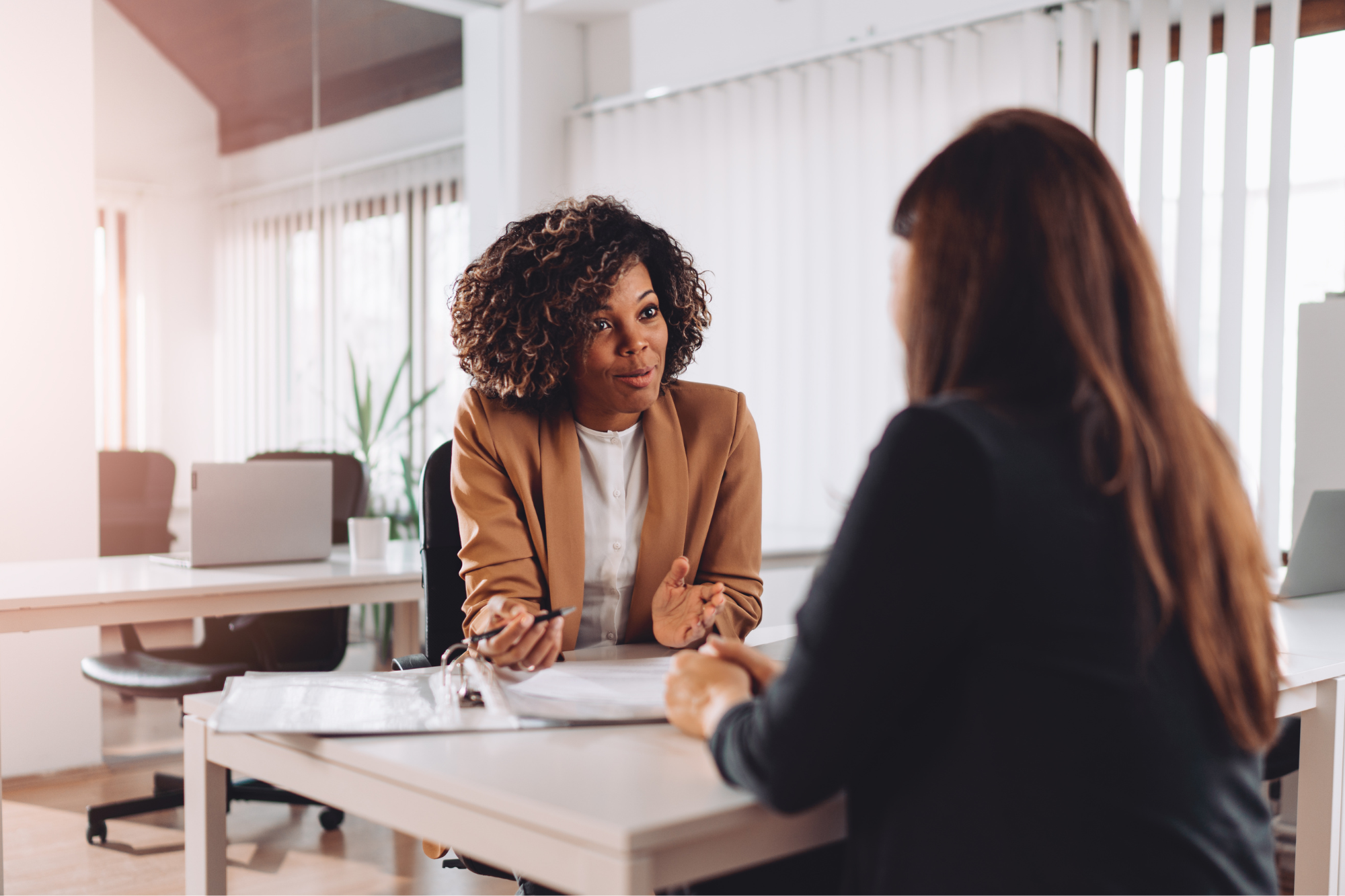 two women discussing at a table