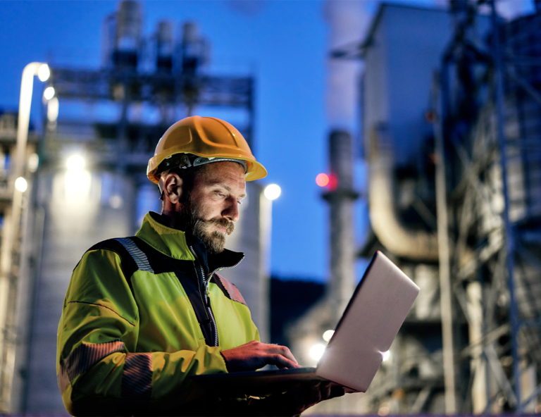 man-in-hard-hat-holding-laptop