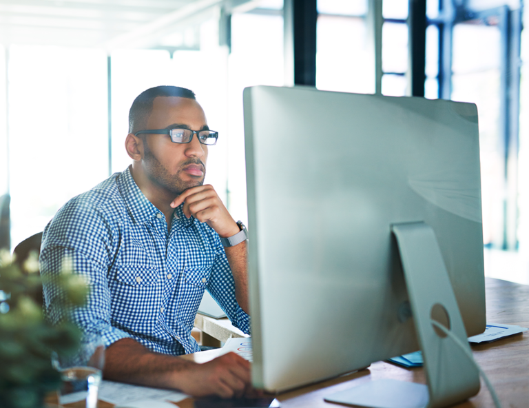 man-wearing-glasses-looking-at-computer-screen