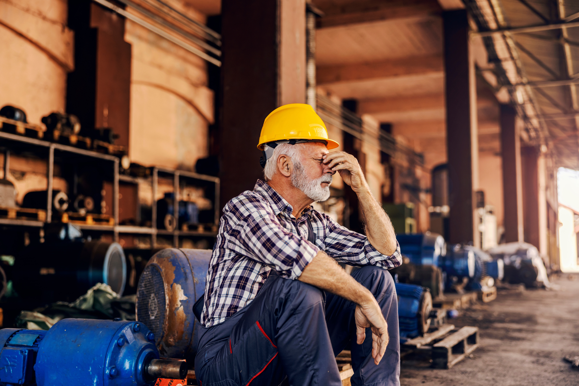 man in safety gear appearing tired